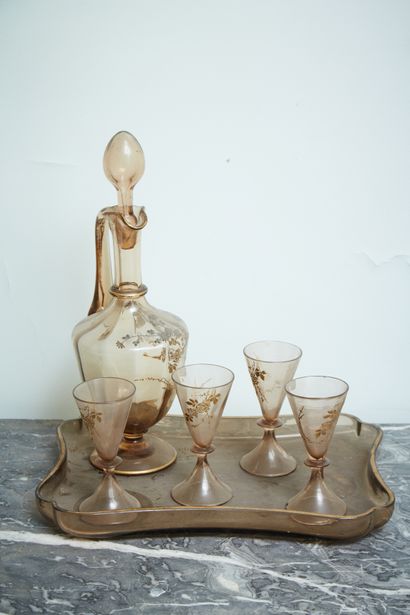 A blown glass carafe with gilded decoration...