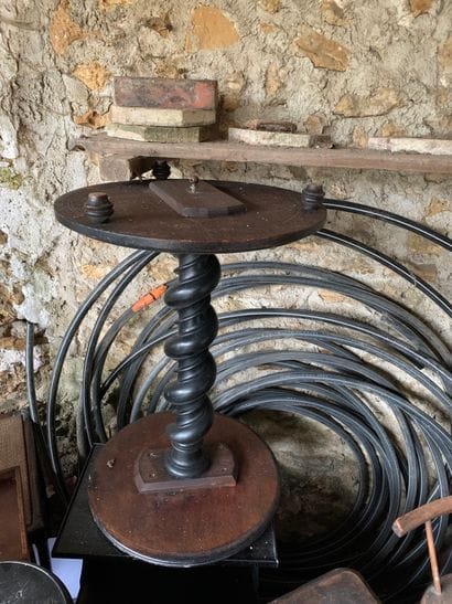 A carved blackened pearwood column with a...