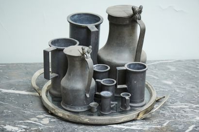 Set of pewter measures and pitchers.