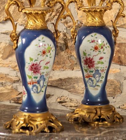 
Pair of candelabras formed by two vases...