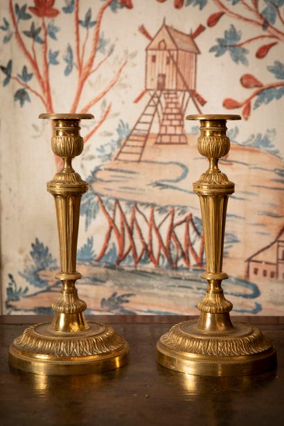 
Pair of ormolu candlesticks with foliage,...