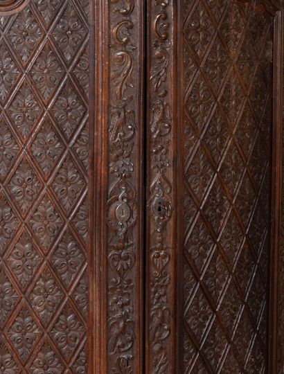 
A carved wood cove opening with two leaves...