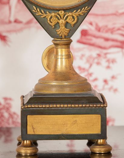 
Cartel in the form of urn in patinated bronze,...