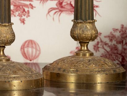 
Pair of ormolu candlesticks, the circular...