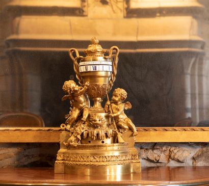 
Gilt bronze clock, the dial turning in an...