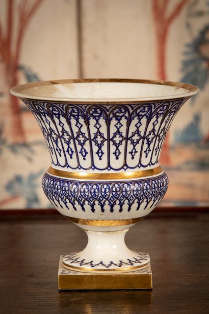 
White porcelain vase with blue and gold...