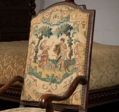 
Armchair in molded and carved natural wood,...
