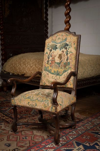 
Armchair in molded and carved natural wood,...