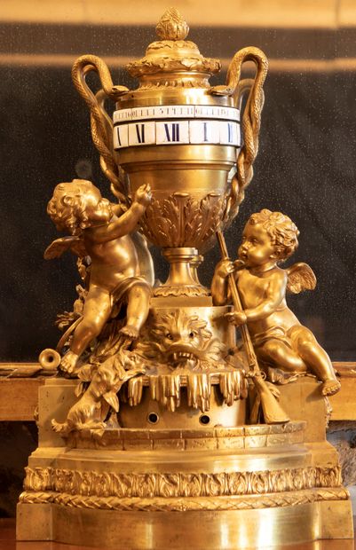 
Gilt bronze clock, the dial turning in an...