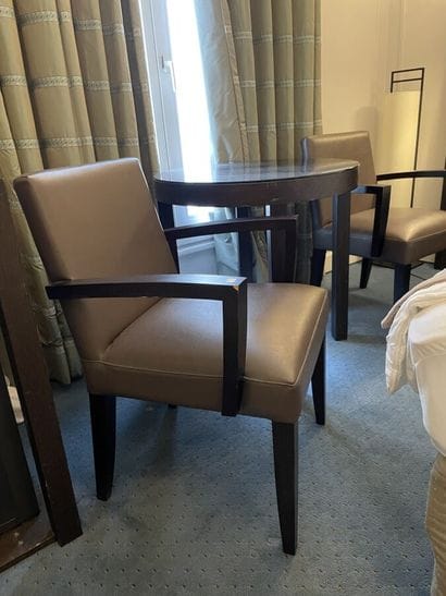 Two wooden armchairs upholstered in taupe...