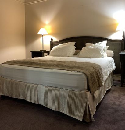 A double bed resting on a single box spring,...