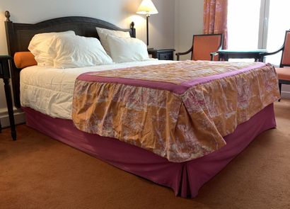 A double bed resting on two box springs,...