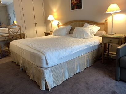 A double bed, rests on two box springs, headboard...