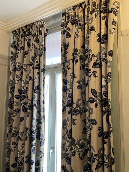 Pair of beige curtains with blue and green...