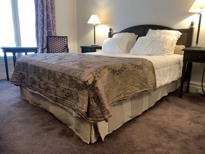 A double bed resting on a single bed base...