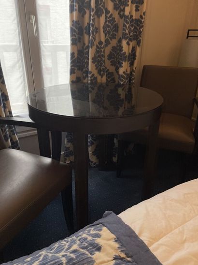 Round wooden table, black tinted mirror surface...