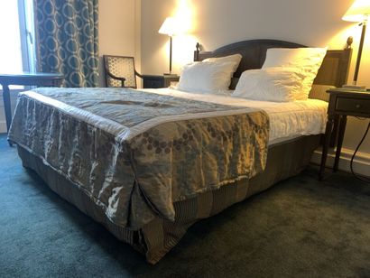 A double bed, rests on a single box spring,...