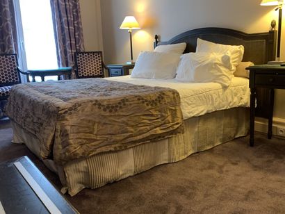 A double bed resting on a single box spring,...