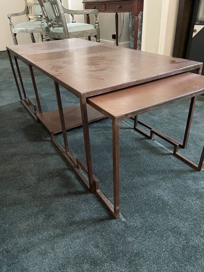 Metal coffee table in which two small tables...