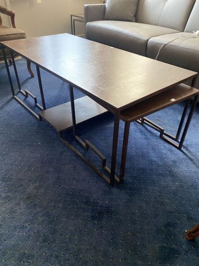 Metal coffee table in which two small tables...