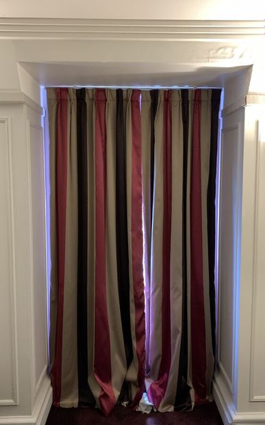 Pair of curtains lined with colored stripes...