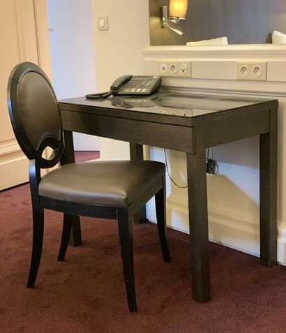 Small black tinted veneer desk opening to...