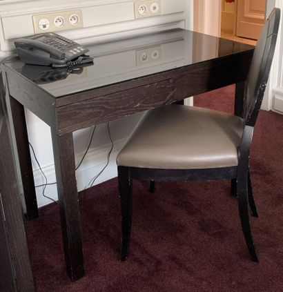 Small black tinted veneer desk opening to...