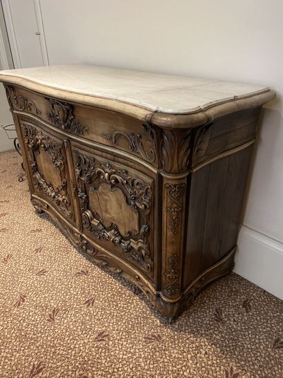 Natural wood chest of drawers opening to...