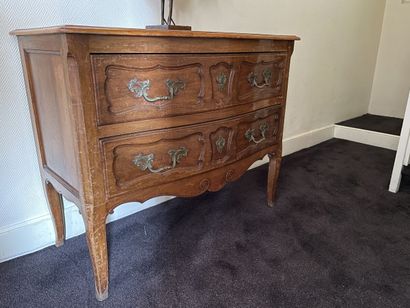 Natural wood chest of drawers opening by...