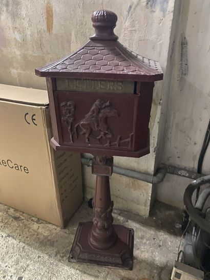 A letter box on foot in metal painted in...