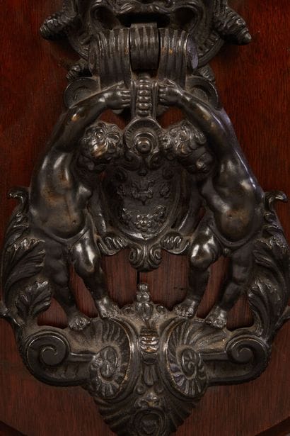 Bronze knocker representing two putti holding...