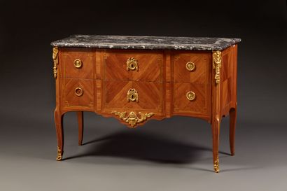 Rosewood chest of drawers with a slight central...