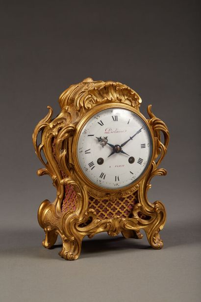 Small table clock in chased and gilded bronze...