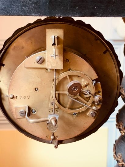 A blackened wood clock with torso columns...