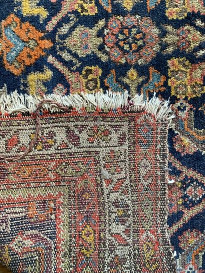 An oriental carpet with a blue background...