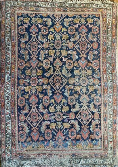 An oriental carpet with a blue background...