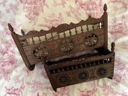 Two miniature cradles of Breton dolls in...