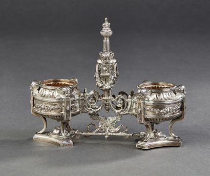 Double silver saleron resting on a tripod...