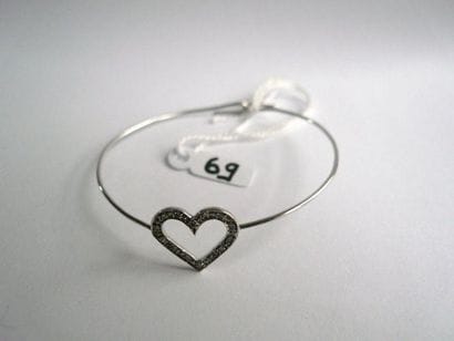 Fin bracelet rigide ouvrant en or gris orné...