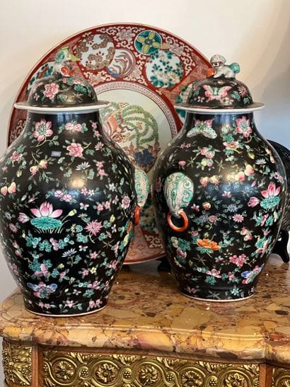 A pair of covered potiches with polychrome...