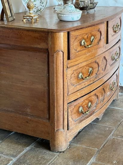 Cherry-wood arched chest of drawers opening...