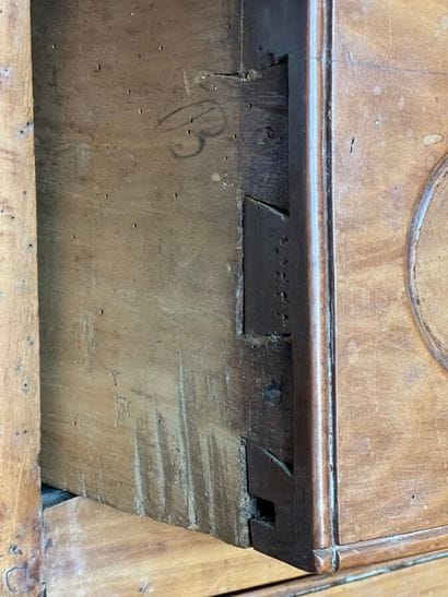 Cherry-wood arched chest of drawers opening...