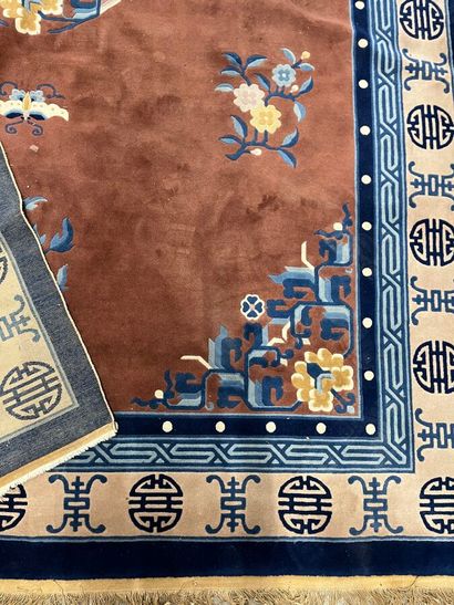 Chinese-style rug with pink background surrounded...