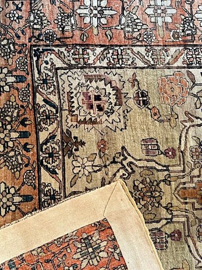 Oriental rug with floral design on a beige...