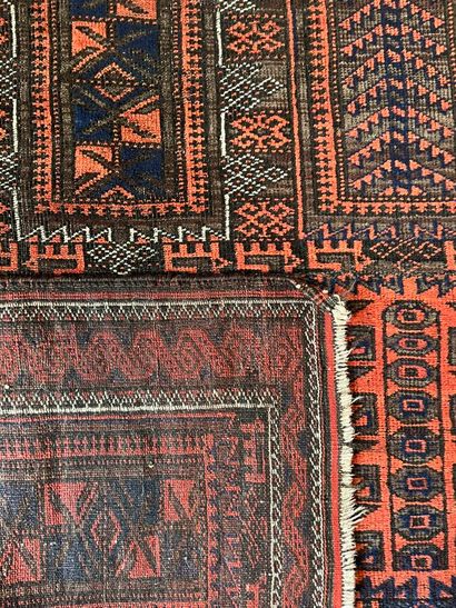 Two Persian rugs: 
- One with a red background:...