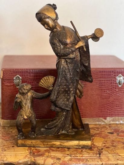 Female figure in bronze playing tambourine...