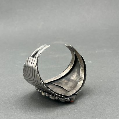 A silver and turquoise bracelet decorated...