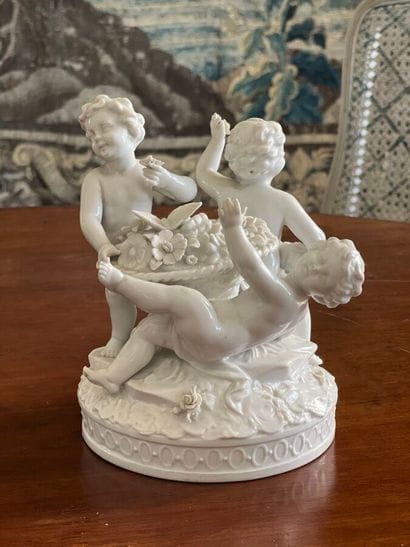 Porcelain group of putti (missing fingers)....