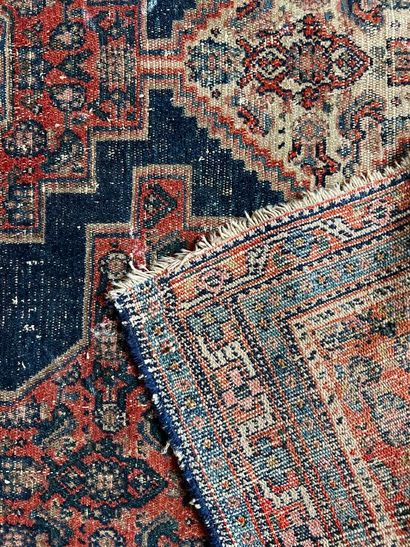 A red Oriental carpet with three medallions...