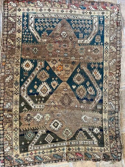 Oriental rug with blue background (many tears...